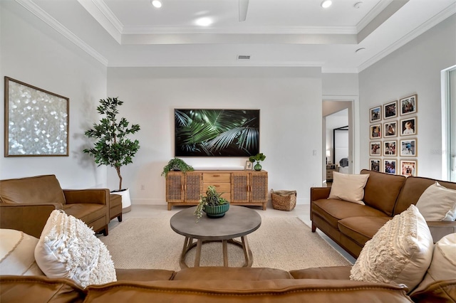 living room featuring a raised ceiling and crown molding