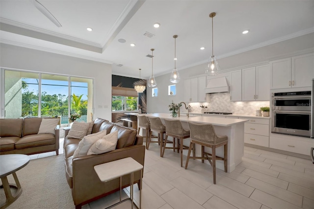 living room featuring ornamental molding and sink