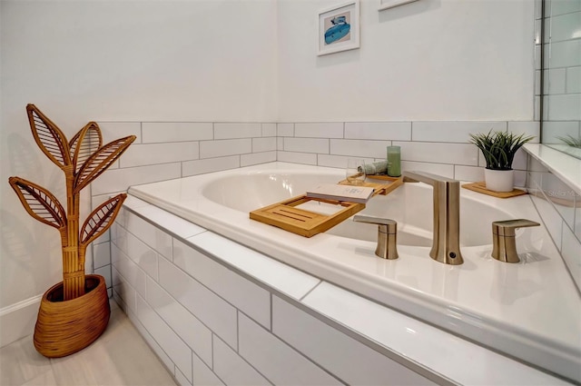 bathroom featuring tiled tub