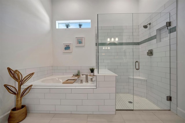 bathroom featuring tile patterned floors and separate shower and tub