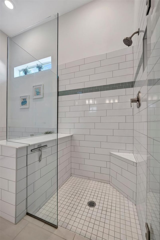 bathroom featuring a shower with door