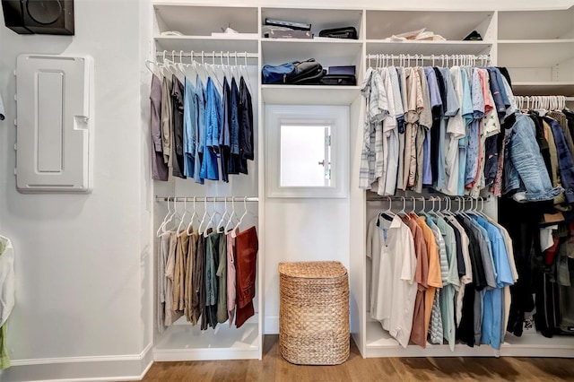 walk in closet featuring wood-type flooring and electric panel