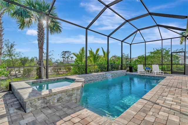 view of swimming pool featuring an in ground hot tub, pool water feature, a lanai, and a patio