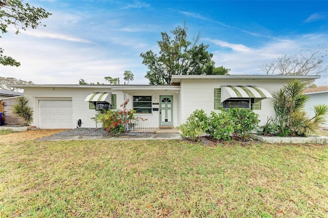 ranch-style home with a garage and a front yard