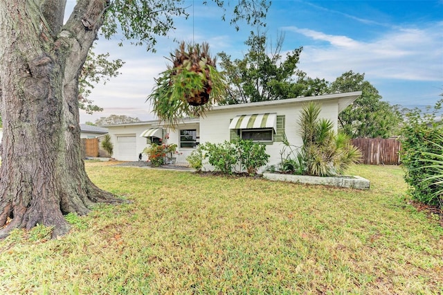 view of front of house with a garage and a front lawn