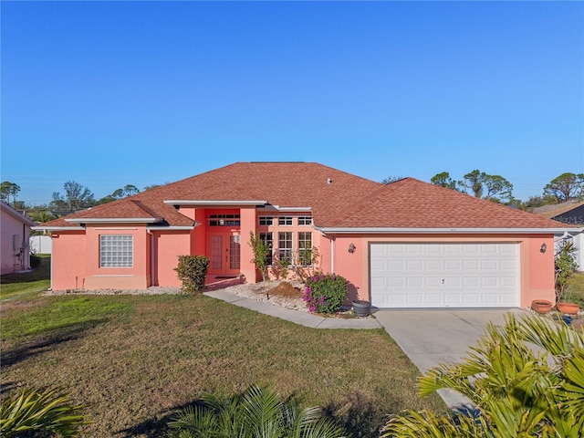 view of front of property featuring a garage and a front yard