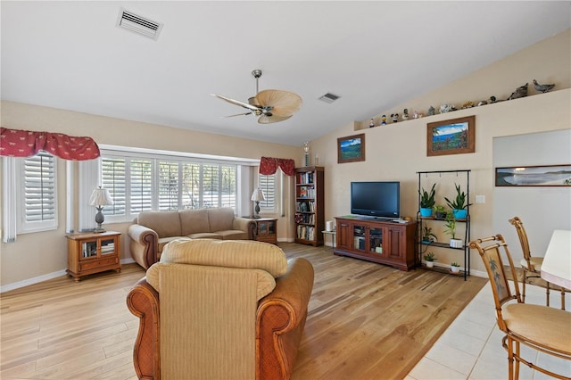 living room featuring ceiling fan, vaulted ceiling, and light hardwood / wood-style flooring