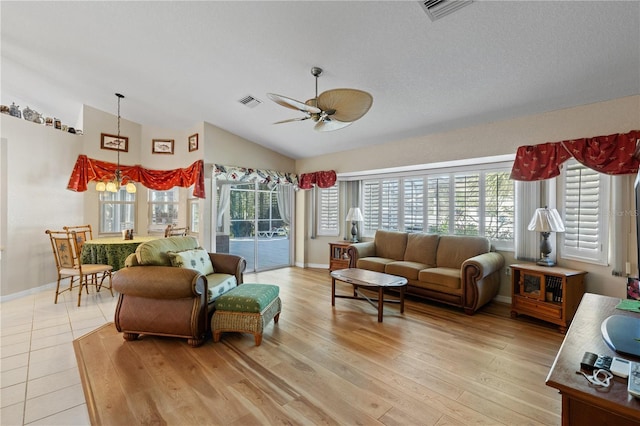 living room featuring vaulted ceiling, ceiling fan, and light hardwood / wood-style floors