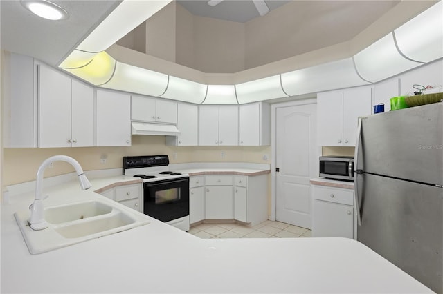 kitchen featuring sink, light tile patterned floors, stainless steel appliances, and white cabinets