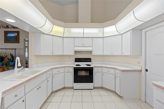 kitchen with range with electric cooktop, sink, light tile patterned flooring, and white cabinets