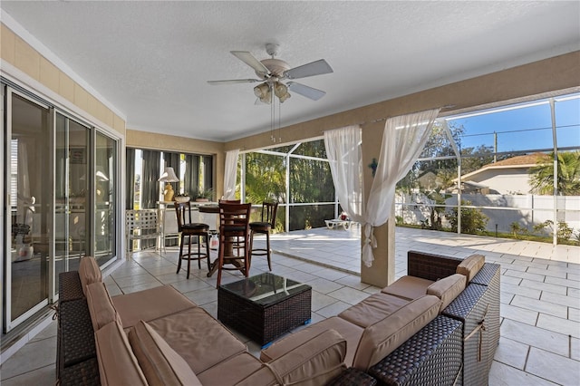 sunroom with ceiling fan