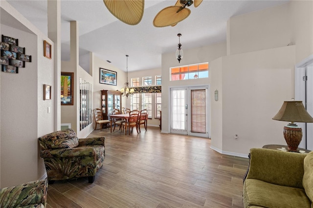 living room featuring hardwood / wood-style flooring and ceiling fan with notable chandelier