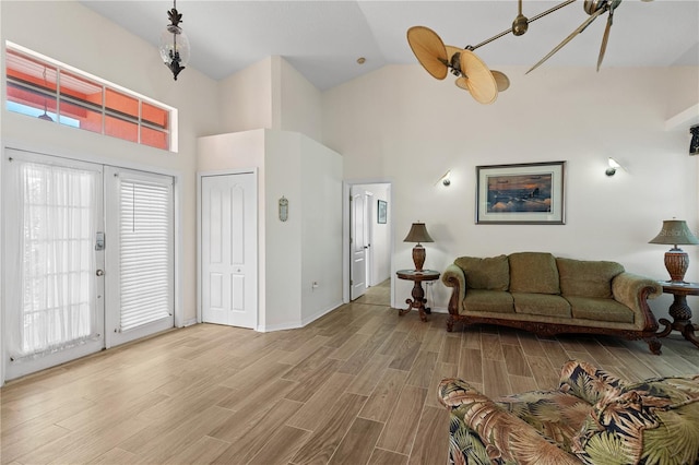 living room featuring ceiling fan, high vaulted ceiling, and french doors