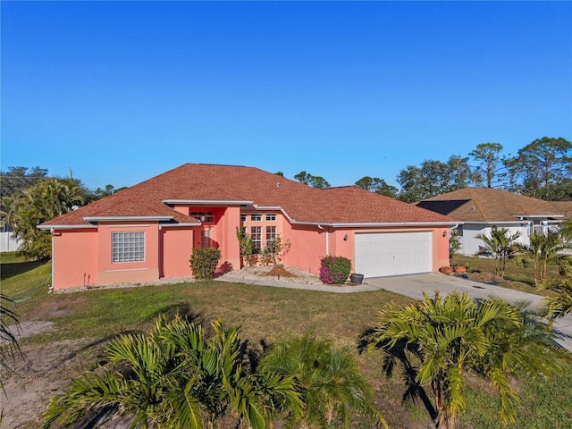 view of front of house featuring a garage and a front lawn