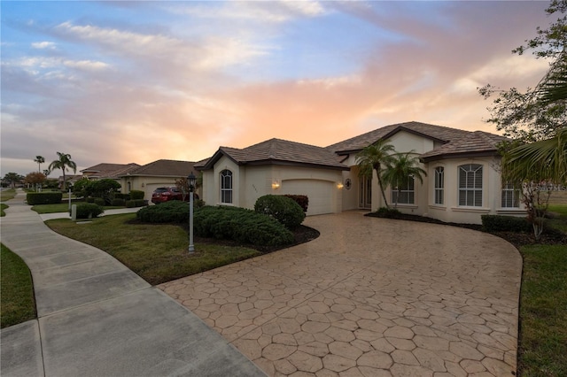 view of front facade with a garage and a yard