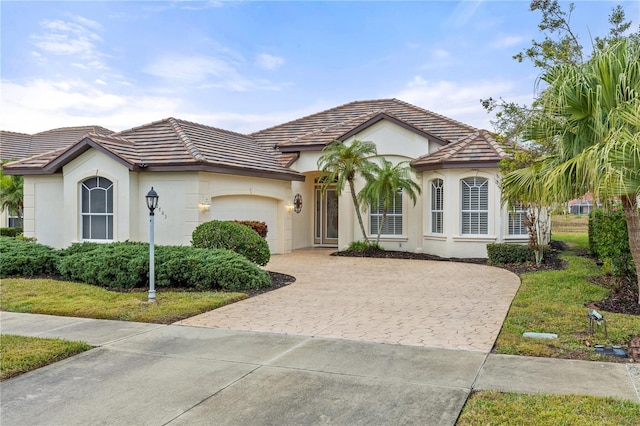 view of front of home with a garage and a front yard