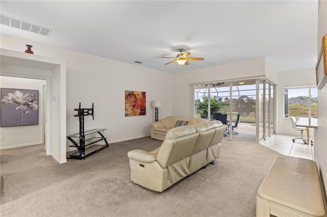 carpeted living room with ceiling fan