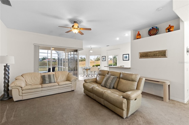 living room with light colored carpet and ceiling fan