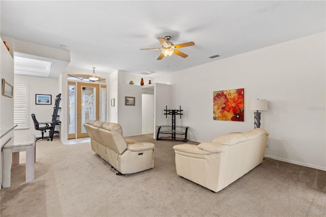 living room with light colored carpet, ceiling fan, and french doors