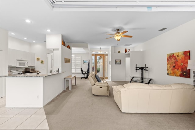 carpeted living room featuring ceiling fan