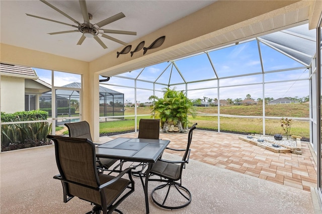 view of patio / terrace with a lanai and ceiling fan