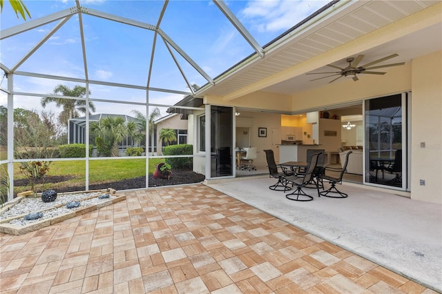 unfurnished sunroom featuring ceiling fan