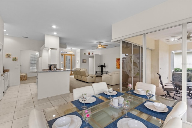 dining space featuring light tile patterned flooring and ceiling fan