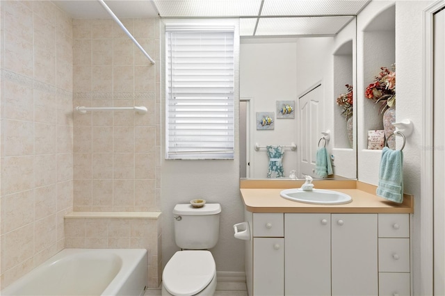 full bathroom with tiled shower / bath, vanity, and toilet