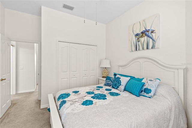 bedroom featuring light carpet and a closet