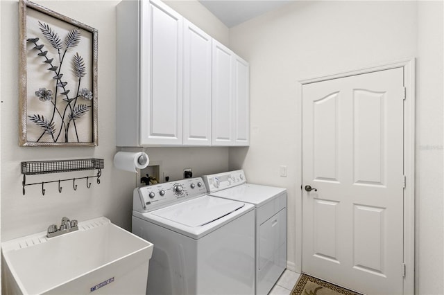 laundry area with sink, cabinets, and washer and dryer