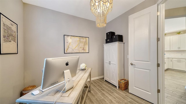 office area featuring a chandelier and light wood-type flooring