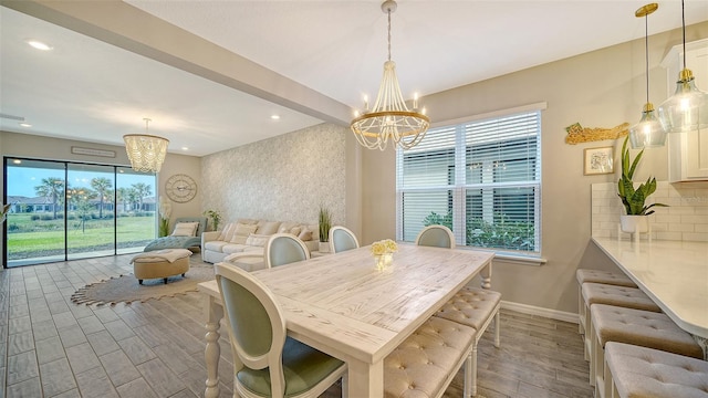 dining area with an inviting chandelier and light hardwood / wood-style floors