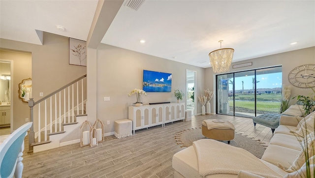 living room featuring light hardwood / wood-style floors and a chandelier