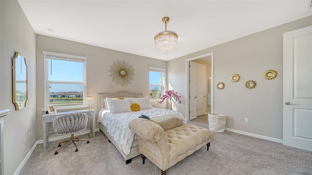 bedroom featuring an inviting chandelier and light carpet