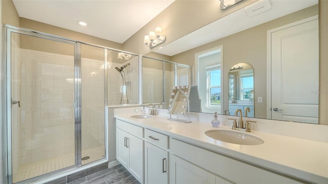 bathroom featuring vanity and a shower with door