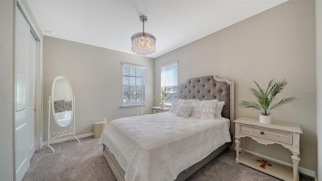 carpeted bedroom with a chandelier