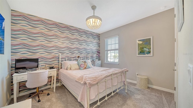 bedroom featuring a notable chandelier and carpet floors