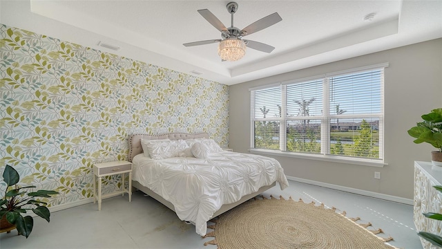 bedroom featuring ceiling fan and a tray ceiling