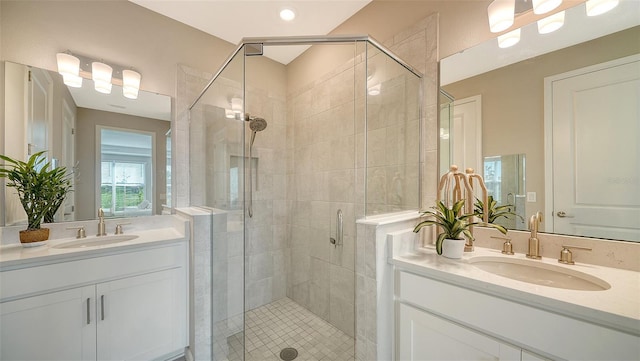 bathroom with walk in shower and vanity