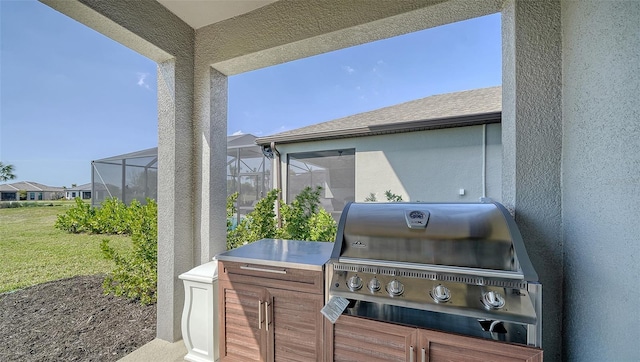 view of patio / terrace with a lanai and area for grilling