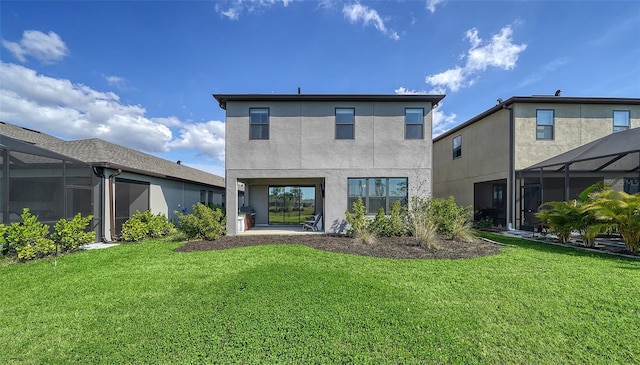 rear view of property with glass enclosure and a lawn