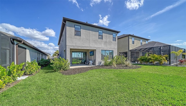 back of property with a yard, a lanai, and a patio area