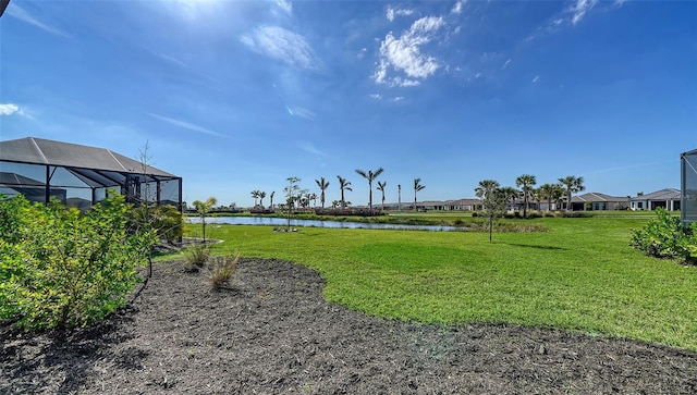 view of yard featuring a water view and a lanai