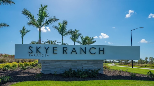 community sign featuring a yard