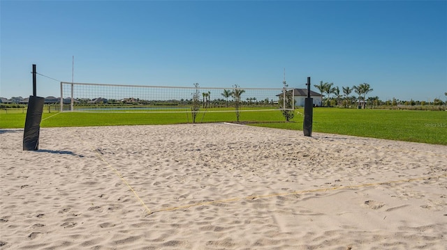 view of property's community featuring a yard and volleyball court