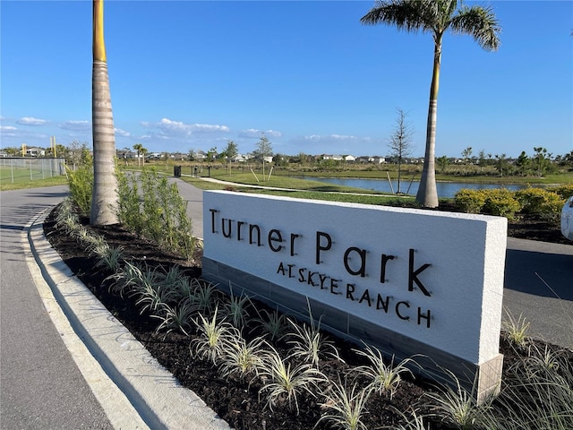 community / neighborhood sign featuring a water view