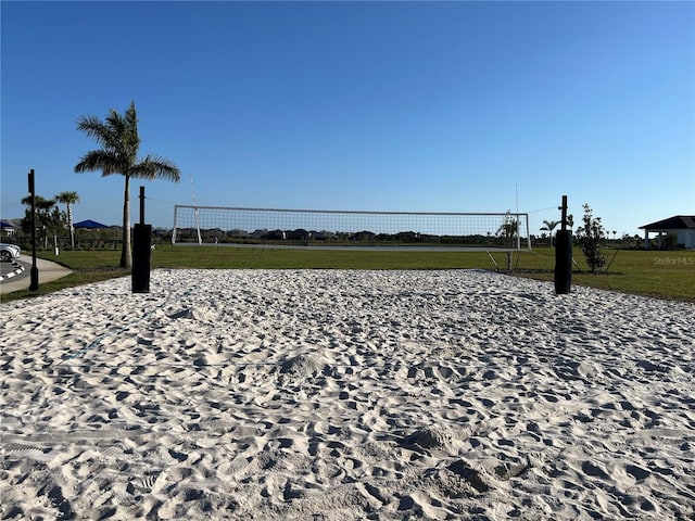 surrounding community featuring a lawn and volleyball court