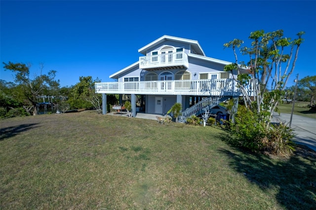 back of house featuring a yard, a deck, and a patio area