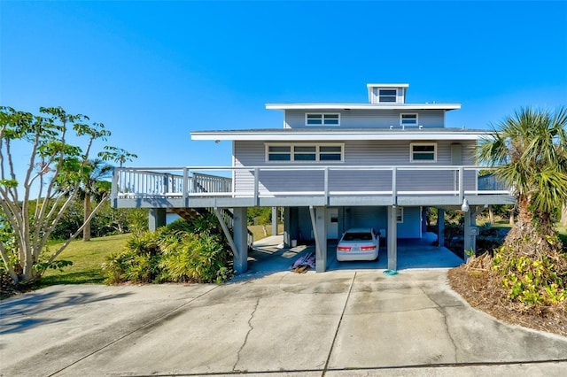 raised beach house featuring a carport