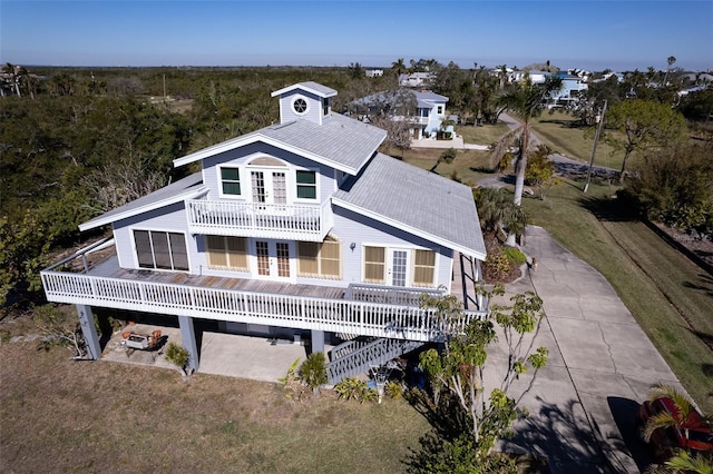 rear view of property featuring a balcony